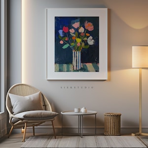 May include: A painting of a bouquet of colorful flowers in a striped vase on a blue and green striped background. The painting is framed in a white frame and hangs on a light gray wall.