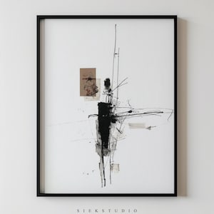 May include: Abstract art print in a black frame. The artwork features black and gray brushstrokes and lines on a white background, with a small brown square and the text "SIEK STUDIO" at the bottom.