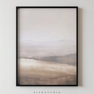 May include: A framed abstract landscape painting with a muted colour palette of browns, greys, and whites. The painting depicts a hazy, distant mountain range with a foreground of rolling hills. The frame is black and the painting is signed "Siek Studio".