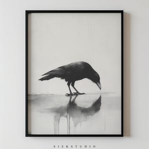 May include: Monochrome framed print of a crow, head bowed, reflected in water. The artwork has a minimalist style with the text "SIEK STUDIO" at the bottom. The image is in a black frame.