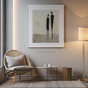 May include: A framed abstract painting of two figures in black against a beige background. The painting is titled "Siekstudio".