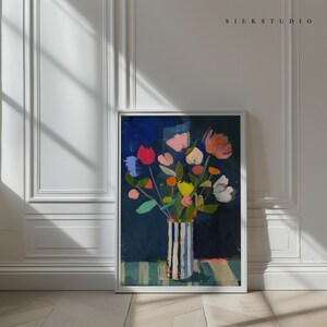May include: A painting of a bouquet of colorful flowers in a striped vase. The flowers are arranged in a vase with blue and white stripes. The background is a dark blue color. The painting is framed in a white frame.