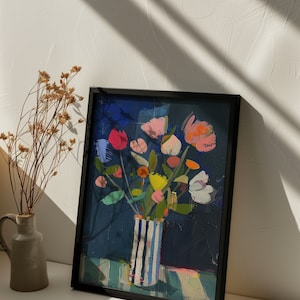 May include: A framed painting of a colorful bouquet of flowers in a striped vase. The flowers are pink, yellow, orange, red, and white. The background is a dark blue.