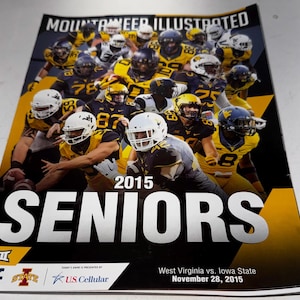 May include: A magazine cover featuring a group of football players in gold and navy uniforms. The text "MOUNTAINEER ILLUSTRATED" is at the top, with "2015 SENIORS" in large white letters. The bottom includes game details.