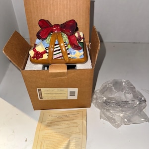 May include: A Longaberger Pottery Little Girls Basket Lid in a box with a red bow and a care guide for stoneware accessories. The box has the Longaberger logo and the number 31655. Made in China.