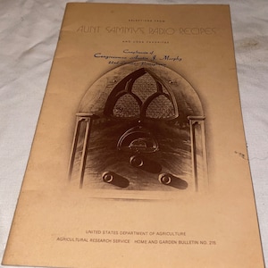 May include: A vintage cookbook cover with a brown background and a black and white image of a radio. The title is "Aunt Sammy's Radio Recipes" and the text below reads "Compliments of Congressman Austin J. Murphy 22nd District, Pennsylvania".