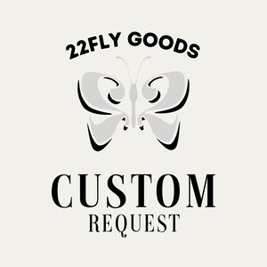 May include: A cream-colored graphic with the text "22FLY GOODS" above a butterfly design and the words "CUSTOM REQUEST" below. The butterfly is light gray with black outlines.