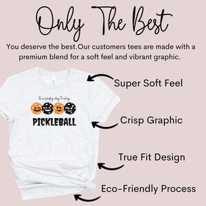 May include: A heather grey t-shirt with a black and orange pumpkin graphic and the text "It's a spooky day to play PICKLEBALL". The shirt is made with a soft, premium blend and features a crisp graphic, true fit design, and eco-friendly process.
