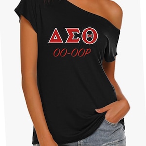 May include: Black off-the-shoulder t-shirt with red and white lettering that reads "ΔΣΘ 00-00P".