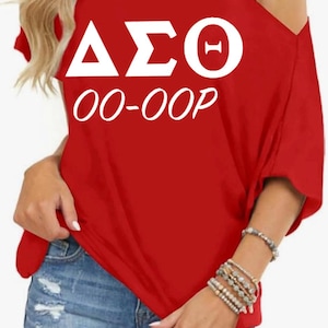 May include: Red off-the-shoulder t-shirt with white lettering that reads "ΔΣΘ 00-00P".
