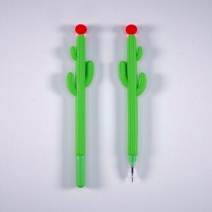 May include: Two green cactus-shaped pens with red flower tops. The pens are on a white background.