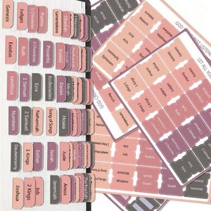 May include: A set of pink and gray Bible tabs with the names of the books of the Bible printed on them. The tabs are designed to be used in a Bible to help you find the books you are looking for.