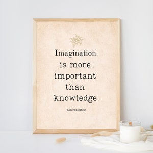 May include: A framed print with a beige background and black text that reads "Imagination is more important than knowledge." The quote is attributed to Albert Einstein.