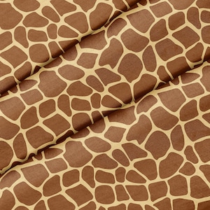 Può includere: Un primo piano di un tessuto marrone e beige con un motivo a stampa di giraffa.