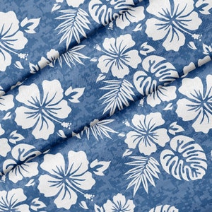 May include: A blue fabric with a white floral pattern. The fabric has a textured surface and is folded in the centre. The floral pattern features hibiscus flowers and leaves.