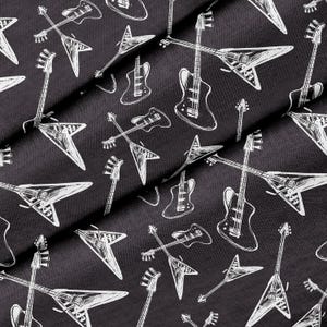 May include: Black fabric with a white repeated pattern of electric guitars. The guitars are in a variety of shapes and sizes.