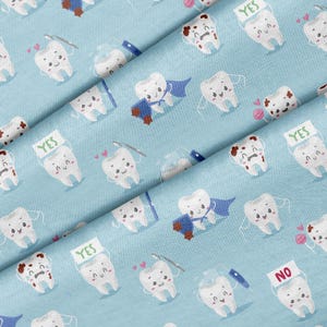 May include: Pale blue fabric featuring a repeating pattern of cartoon teeth. Some teeth wear capes, some have cavities, and some display a "YES" sign. Other teeth are using dental floss.