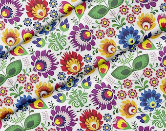 May include: White fabric with a repeating pattern of colorful flowers and leaves. The flowers are stylized and have a folk art feel. The fabric is perfect for crafting projects like quilts, pillows, and bags.