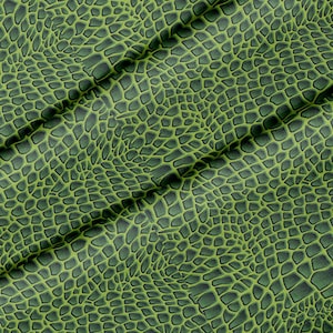 May include: Green fabric with a textured pattern resembling a snake skin.