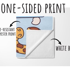 May include: A one-sided print towel with a cartoon giraffe design on a light blue background. The front is fade-resistant polyester, and the back is white. Text on the image reads "ONE-SIDED PRINT" and "WHITE BACK".
