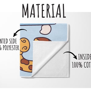 May include: A folded towel with a giraffe cartoon design. The printed side is 100% polyester, and the inside is 100% cotton. The towel has a light blue background with a giraffe illustration in brown and yellow.
