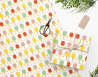 May include: White wrapping paper with a repeating pattern of paddleball rackets, balls, and the text "Paddl Party". A smaller gift box is wrapped with the same paper and tied with twine.
