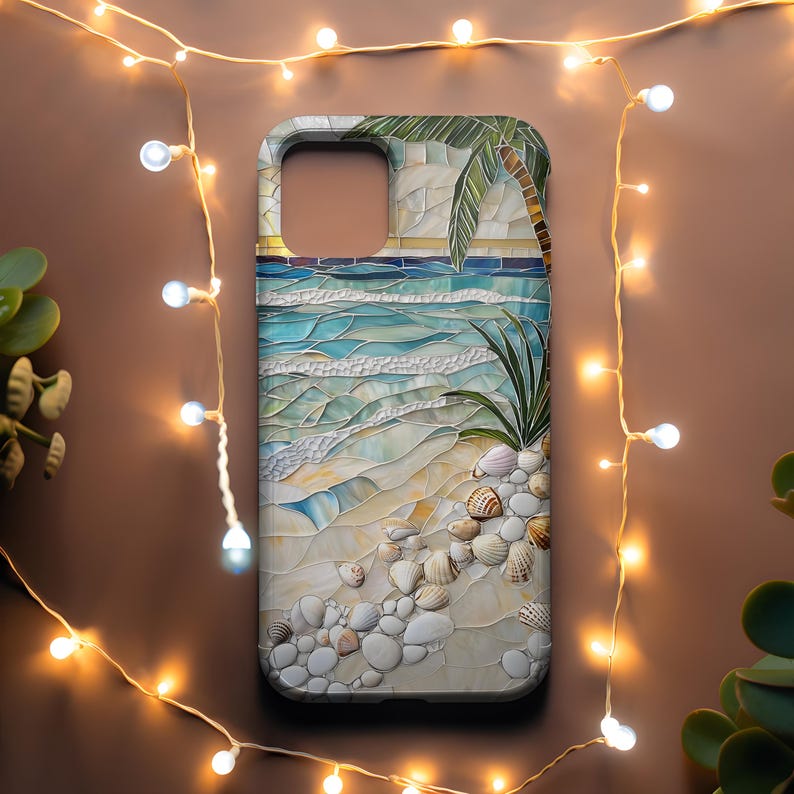 May include: A phone case featuring a mosaic design of a beach scene. The case depicts a palm tree, ocean waves, seashells, and sand in shades of blue, beige, and white. The case is surrounded by a string of warm white lights.