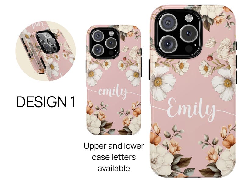 May include: A pink phone case with a floral design and the name "Emily" written in white. The case has a white background with pink flowers and green leaves. The name "Emily" is written in a cursive font.