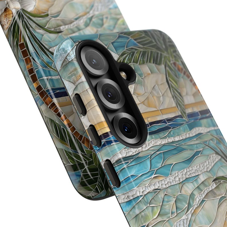 May include: A mosaic-style phone case featuring a beach scene with palm trees, ocean waves, and a sunset. The case has a multi-lens camera cutout and a textured, artistic design. The color palette includes blues, greens, and yellows.