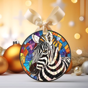 May include: A round Christmas bauble featuring a colourful mosaic design of a zebra's head. The zebra has black and white stripes and is set against a background of bright colours, including blue, green, yellow, and orange.