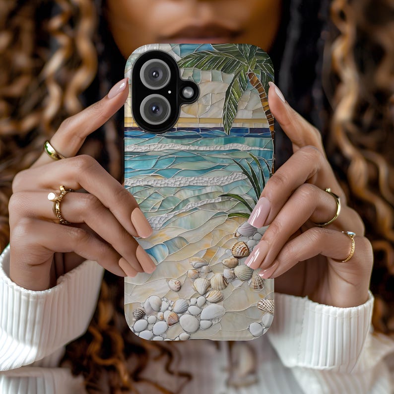 May include: A phone case featuring a mosaic design of a beach scene with a palm tree, ocean waves, and seashells. The case has a glossy finish and a dual-camera cutout.