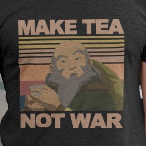 May include: A black t-shirt featuring a vintage-style graphic of a cartoon character holding a cup. The graphic reads "Make Tea Not War" in white text.