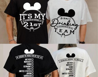 May include: Black and white t-shirts with Mickey Mouse ears and text. One shirt says "It's My 21st" and "Celebrating My Birthday". The other says "Disney Drinking Team Celebrating My 21st". The backs of the shirts list countries.