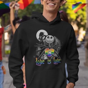 May include: Black hooded sweatshirt with a graphic of Jack Skellington from The Nightmare Before Christmas holding a rainbow heart with the text "Love is Love".