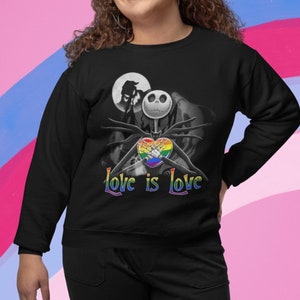 May include: Black sweatshirt with a graphic of Jack Skellington from The Nightmare Before Christmas holding a rainbow heart. The text "Love is Love" is printed below the graphic.