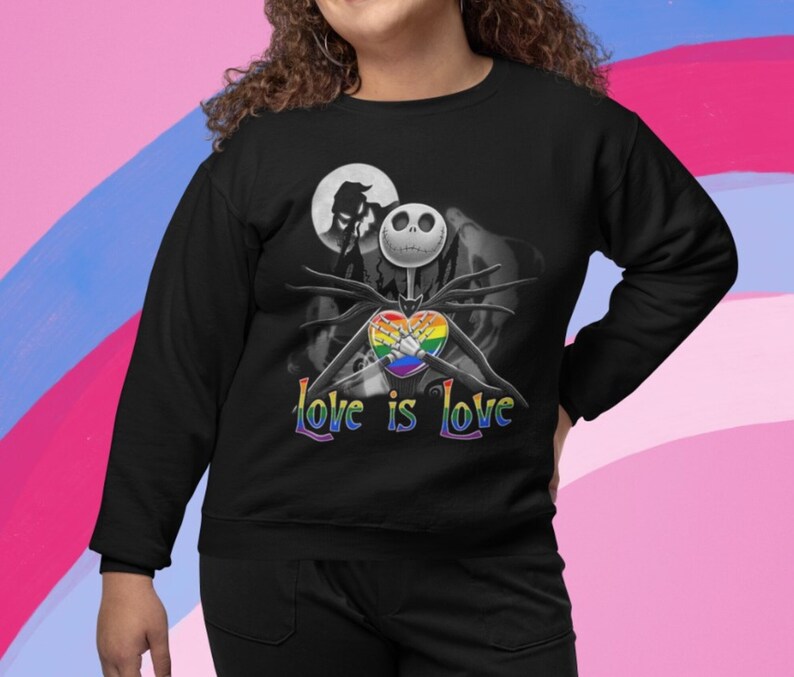 May include: Black sweatshirt with a graphic of Jack Skellington from The Nightmare Before Christmas holding a rainbow heart. The text "Love is Love" is printed below the graphic.