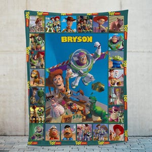 May include: A personalized fleece blanket featuring characters from the animated film "Toy Story." The blanket has a teal border with character images and the text "TOY STORY." The center features Buzz Lightyear and the name "BRYSON" on a blue background.