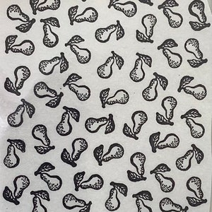 May include: A white background with a repeating pattern of black pears. The pears are drawn in a simple, stylized manner with a single leaf.