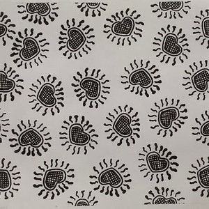 May include: A white background with a repeating pattern of black hearts with radiating lines around them.