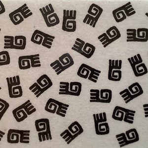 May include: A sheet of black and white stickers with a repeating pattern of stylized swirls. The swirls are arranged in a random pattern.