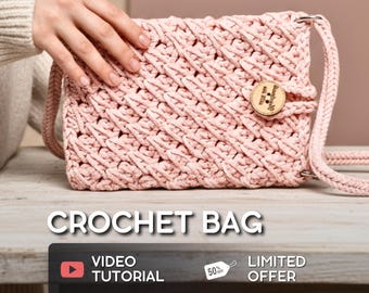 May include: A light pink crochet bag with a textured pattern. The bag has a long strap and a wooden button closure. The text "CROCHET BAG" is displayed in white letters. A video tutorial is available.