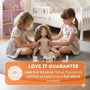 May include: Two young girls in floral dresses play with a handmade doll with long brown hair and a floral crown. The doll is wearing a beige outfit and is seated on a gray rug. A miniature table and chairs are in front of the doll. The image includes the text "LOVE IT GUARANTEE".