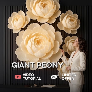 May include: A wall display of multiple large, cream-colored paper peony flowers arranged on a black slatted background. The text GIANT PEONY, VIDEO TUTORIAL, and LIMITED OFFER 50% OFF are visible. A person in a white suit stands to the right side.