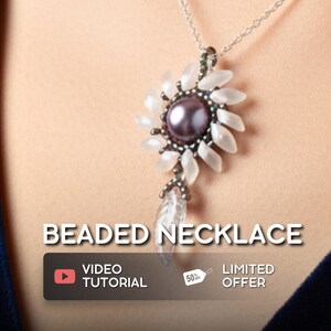 May include: A beaded necklace with a silver chain. The pendant features a dark purple center stone surrounded by white petal-shaped beads. The necklace has a clear, teardrop-shaped bead hanging below. Text on the image reads "BEADED NECKLACE".