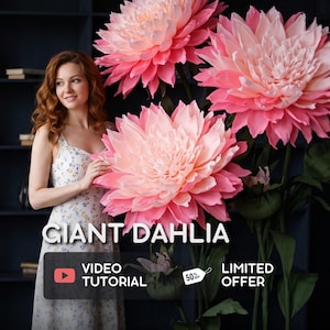 May include: Three oversized artificial dahlia flowers with layered pink and white petals on tall green stems. The text GIANT DAHLIA, VIDEO TUTORIAL, and LIMITED OFFER with a 50% off tag are displayed over the image of the large floral decorations.
