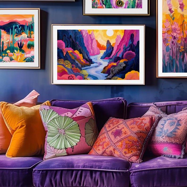 May include: A purple velvet sofa with colorful throw pillows. The pillows feature floral and geometric patterns. The sofa is in front of a blue wall with framed artwork featuring colorful landscapes.