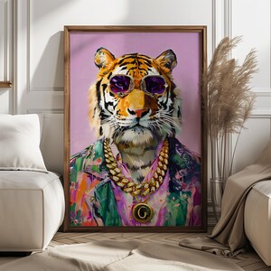 May include: A framed art print depicting a tiger wearing purple sunglasses, a gold chain necklace with a pendant, and a colourful jacket. The tiger is set against a pink background.