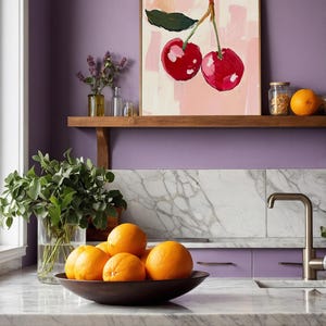 May include: A painting of two red cherries on a pink background, hanging on a shelf above a kitchen counter with a bowl of oranges. The kitchen has a purple wall and marble countertops.