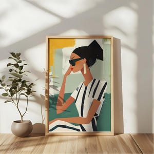May include: A framed illustration of a woman wearing sunglasses and a striped shirt. The background is a colorful abstract design.