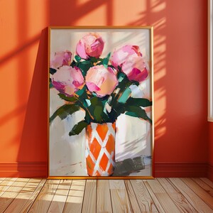 May include: A framed floral painting featuring a bouquet of pink peonies in a vase. The vase is orange with a white diamond pattern. The painting is set against a neutral background with green leaves.